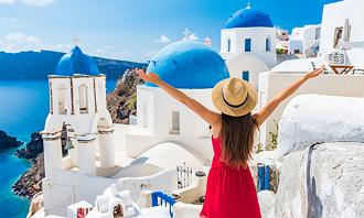 European getaways, Online Travel Agent. Woman enjoying a town in Greece.